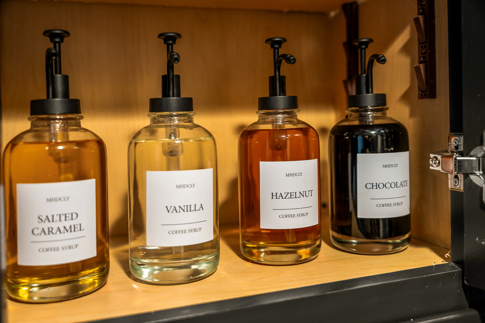 Coffee syrups arranged in a cabinet